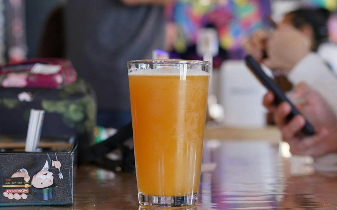 a glass of orange juice sitting on top of a table