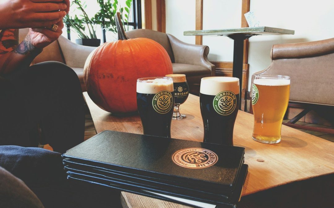 Pumpkin beers and a pumpkin on a taproom table